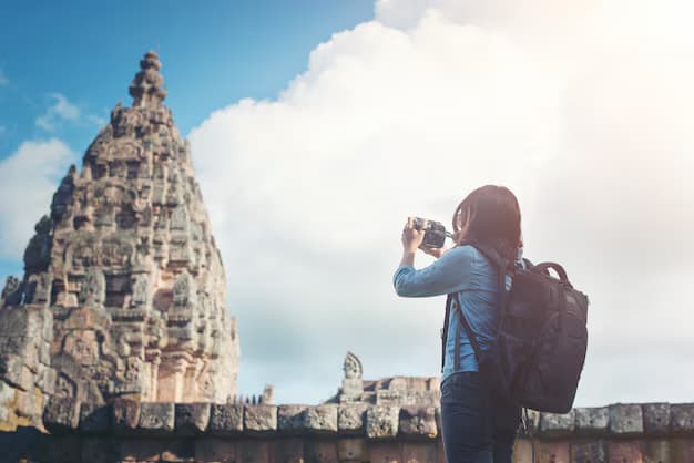 Photographer capturing the details of an ancient stone temple